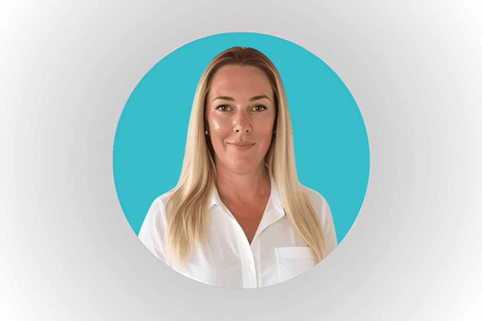 Person with long blond hair wearing a white shirt, posed against a blue background.